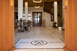 a hallway with a mat with the word misteriasis on the floor at Μikri Arktos Boutique Hotel in Dhimitsana