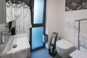 a bathroom with a white toilet and a sink at Ankerplatz in Büsum +10 photos