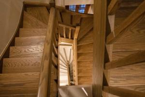a spiral staircase in a house with wooden floors at Μikri Arktos Boutique Hotel in Dhimitsana