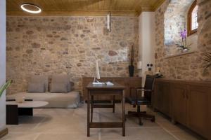 a living room with a couch and a table at Μikri Arktos Boutique Hotel in Dhimitsana