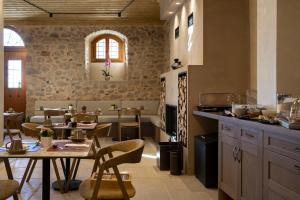 a kitchen with a table and chairs in a room at Μikri Arktos Boutique Hotel in Dhimitsana