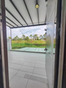 an open door with a view of a tennis court at UG Homestay BP - Netflix & 4 Air-Con Rooms in Batu Pahat