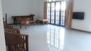 a living room with chairs and a table and a television at Villa 61 - Capital of Sri Lanka in Pagoda