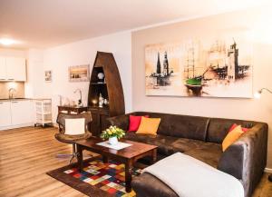 a living room with a couch and a table at Appartement Abendsonne in Büsum