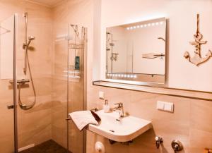 a bathroom with a sink and a shower at Appartement Abendsonne in Büsum +19 photos