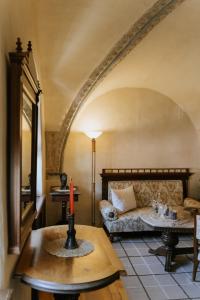 a living room with a couch and a table at Fronius Boutique Residence in Sighişoara
