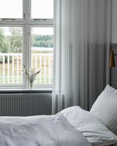 Postel nebo postele na pokoji v ubytování Hotel Ny Hattenæs