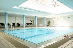 a large swimming pool in a building with a ceiling at Rosenblick (E8) in Büsum