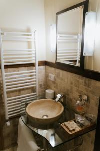 a bathroom with a wooden sink and a mirror at Fronius Boutique Residence in Sighişoara