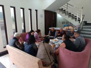 a group of people sitting around a table eating at Hotel saanjh haveli in Orchha