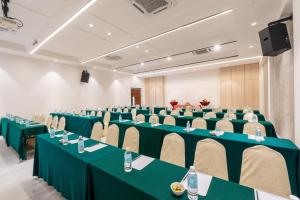 a conference room with green tables and chairs at Victoria Garden Hotel in George Town