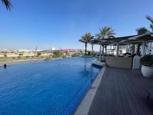 a swimming pool at a resort with blue water at Spacious Studio in Yas Island 113A1 in Abu Dhabi