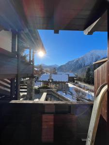 a view from the porch of a house with a mountain at la saxe coumayeur in Courmayeur