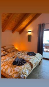 a bedroom with a bed with clothes on it at Golfchalet 3 confini in Tarvisio