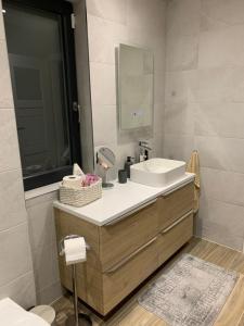 a bathroom with a sink and a mirror at 2 bed Cozy Home Lusk - 15min from Dublin airport! in Lusk