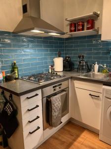 a kitchen with a stove and a sink at 2 bed Cozy Home Lusk - 15min from Dublin airport! in Lusk