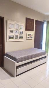 a bed frame in a room with a mattress at Womy Homy in Bogor