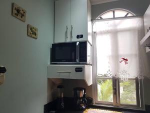 SamborondÃ³n的住宿－Habitacion independiente en Samborondon，厨房配有微波炉和窗户。