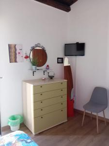 um quarto com uma cómoda, um espelho e uma cadeira em Guest House Beati Paoli em Palermo