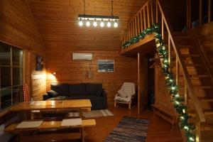 a living room with a couch and a table at Muotkan Ruoktu Tunturikyla in Inari