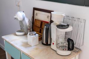 a counter with a coffee maker and a blender on it at Casa da Judiaria Velha AP in Viseu