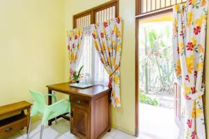 a home office with a desk and a window at Villa Alicia in Yogyakarta