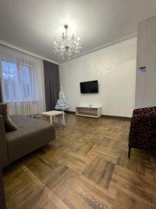 a living room with a couch and a christmas tree at Apartment on Soborna 101 in Vinnytsya