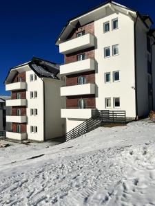 an apartment building in the snow at Ramondia, Kopaonik in Kopaonik