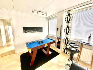 a living room with a pool table in it at City Stay Apartments in Jyväskylä