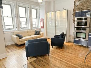 a living room with a couch and a stove at The Historic Lyric Penthouse with Private Rooftop in Cincinnati