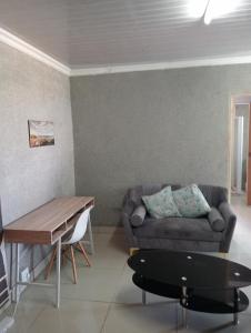 a living room with a couch and a table at Ngena guesthouse in Cape Town