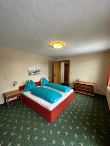 a bedroom with a large bed with blue pillows at Apartments Pichler in Neukirchen am Großvenediger