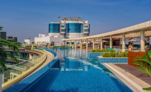 a large swimming pool in a city with buildings at Studio with pool and private beach access on Palm Jumeirah in Dubai