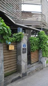a building with two plants on the side of it at Hanso Presidential Suite Hanok Hotel in Seoul