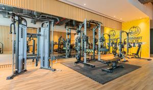 a gym with several tread machines in a room at Studio with pool and private beach access on Palm Jumeirah in Dubai