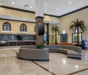 a lobby with couches and palm trees in a hotel at Charming seaside studio for 4 people! - Rate included resort fee-Parking fee not included- in Sunny Isles Beach