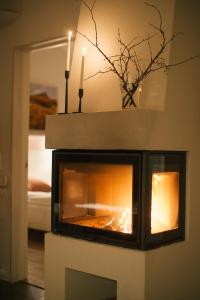 a fireplace with two candles in a living room at Fjällfrid stugby in Bruksvallarna