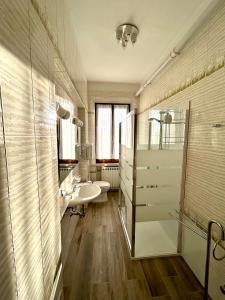 a bathroom with a sink and a toilet and a mirror at Dimora '800 in Ferrara