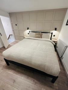 a bedroom with a large bed in a room at The Nook Cottage, Parkgate, Wirral in Parkgate