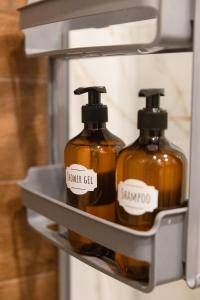 two bottles of soap on a shelf in a refrigerator at Glečer Kop, Cozy design apartment A5 in Kopaonik