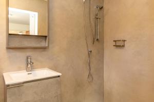 a bathroom with a sink and a shower at Playa Feliz Apartments Bonaire in Kralendijk