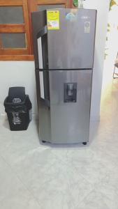 a stainless steel refrigerator next to a trash can at habitacion privada en Jardin cerca al parque in Jardin