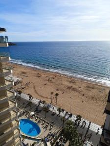 a view of the beach from the balcony of a hotel at Apartamento Currus Miramar Playa in Benidorm