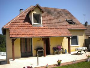 a house with an orange roof with a patio at claude et chantal in Saint-Yorre