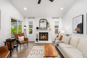 a living room with a white couch and a fireplace at Sacramento Gem w Cozy Wood Fireplace BBQ Grill in Sacramento