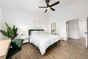 a white bedroom with a bed and a ceiling fan at Sacramento Gem w Cozy Wood Fireplace BBQ Grill in Sacramento
