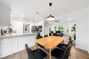 a kitchen and living room with a wooden table and chairs at Sacramento Gem w Cozy Wood Fireplace BBQ Grill in Sacramento