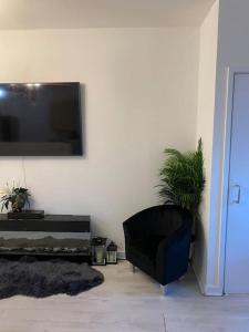 a living room with a flat screen tv on a wall at Cozy Peckham Apartments in London