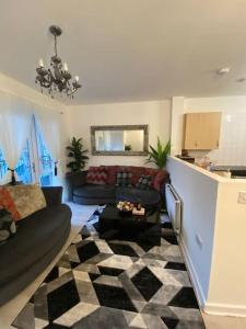 a living room with a couch and a table at Cozy Peckham Apartments in London