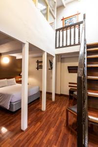 a bedroom with a bed and a stair case at La Casona de Rimacpampa in Cusco